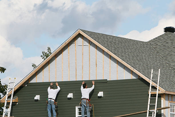 Professional Storm Damage Siding Repair technician working in Somerset, TX